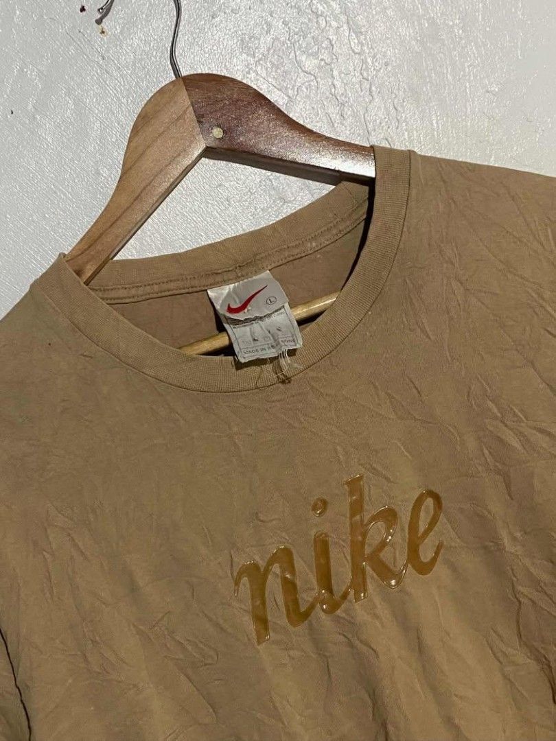 Vintage Nike Script Logo Brown T-Shirt (Category: Tshirts & Polo Shirts ) located in Maasin. Submitted by trippythirftyyy (Listing ID 1465091998, Image 2). Description: - Brand: Nike - Color: Tan Brown - Design: Script logo across the chest - Size: Large - Fit: Boxy vintage fit - Material: 100% cotton - Era: Vintage (Made in Hong Kong tag) - Condition: Great classic streetwear piece, easy to style -excellent condition -no issue, need wash only.