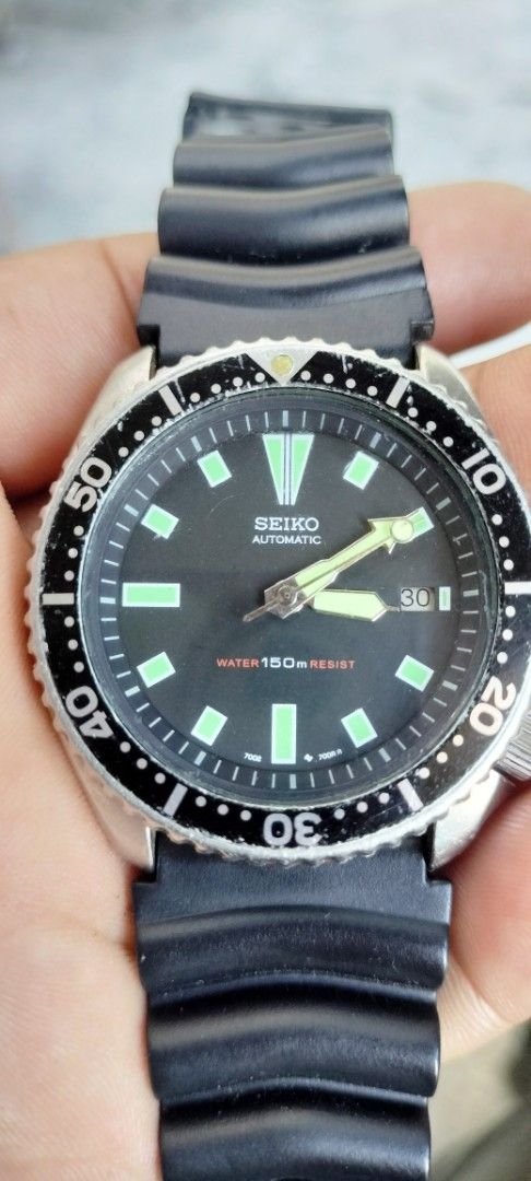 Vintage Seiko Automatic Diver Watch 150m (Category: Men's Watches) located in Manila. Submitted by eilrahc19773465 (Listing ID 1465029287, Image 1). Description: - Brand: Seiko - Movement: Automatic - Dial: Black with luminous hands and hour markers - Features: Rotating bezel, date window at 3 o'clock - Water Resistance: 150m - Strap: Black ribbed rubber strap - Condition: Pre-owned with visible scratches on the case and bezel insert from past we