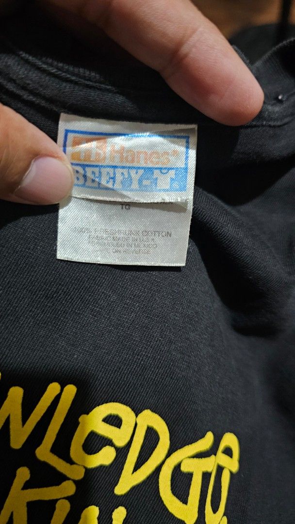 Vintage Stüssy Knowledge Is King Ringer Tee (Category: Tshirts & Polo Shirts ) located in Kibawe. Submitted by Thrift_ni_Babac (Listing ID 1465005327, Image 3). Description: - Bootleg Stüssy ringer tee on a Hanes Beefy-T label - Color: Black with yellow sleeve stripes - Graphics: 'Knowledge Is King' front print with yellow figure/red crown, and large number 1 on the back - Material: 100% pre-shrunk cotton - Dimes: 18W x 26L - Condition: Shows nor