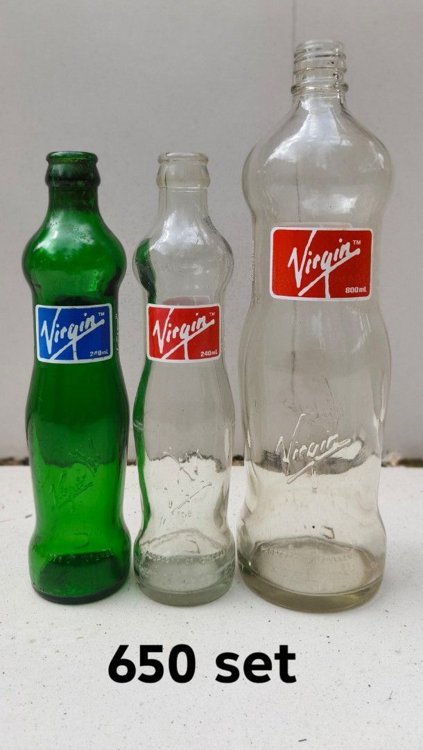 Vintage Virgin Glass Bottles Set 650 (Category: Vintage Collectibles) located in Manila. Submitted by botecollectorsph (Listing ID 1465112004, Image 1). Description: - Set of 3 vintage Virgin glass bottles ideal for display or collection - Includes two smaller 240mL bottles (1 green, 1 clear) with red and blue labels - Includes one larger 800mL clear bottle with a red label - Features classic embossed lettering near the base of all pieces - Clean