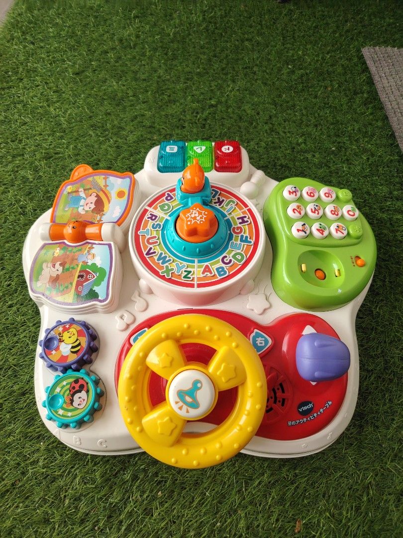 VTech Interactive Activity Learning Table Top Toy (Category: Infant Playtime) located in Nusajaya. Submitted by qalbebe (Listing ID 1464981513, Image 1). Description: Stand dgn phone je xde ,lain sound and lampu semua function..boleh pm utk video - VTech interactive learning toy panel for toddlers - Features a colorful steering wheel, spinning gears, and alphabet wheel - Animal telephone keypad, flip-book, and piano keys with Japanese characters 