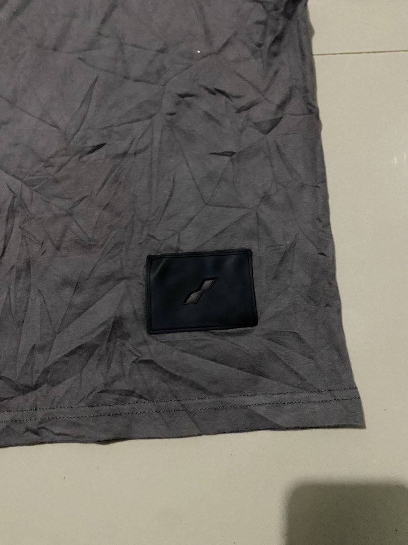 WE11DONE Grey Short Sleeve T-Shirt (Category: Tshirts & Polo Shirts ) located in Makati City. Submitted by dymon_08 (Listing ID 1465101942, Image 3). Description: - Brand: WE11DONE - Dimes W16.5 L18 - Color: Dark grey - Fit: Relaxed streetwear fit with crew neck - Details: Small box logo on chest, bold colorful lettering graphic on the back - Condition: Excellent, clean fabric with no stains or rips - Perfect everyday tee to style with jeans or c