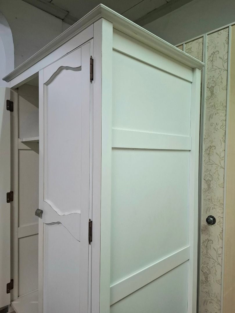 White 2-Door Wardrobe with Double Bottom Drawers (Category: Shelves, Cabinets & Racks) located in Quezon City. Submitted by japandemanila (Listing ID 1465007758, Image 2). Description: - Color: Solid white - Material: Sturdy wood with metal knobs - Storage: Double doors, interior hanging rail, and upper shelf - Drawers: Two large pull-out drawers at the bottom - Design: Elegant decorative molding on doors - Condition: Clean interior and very stur
