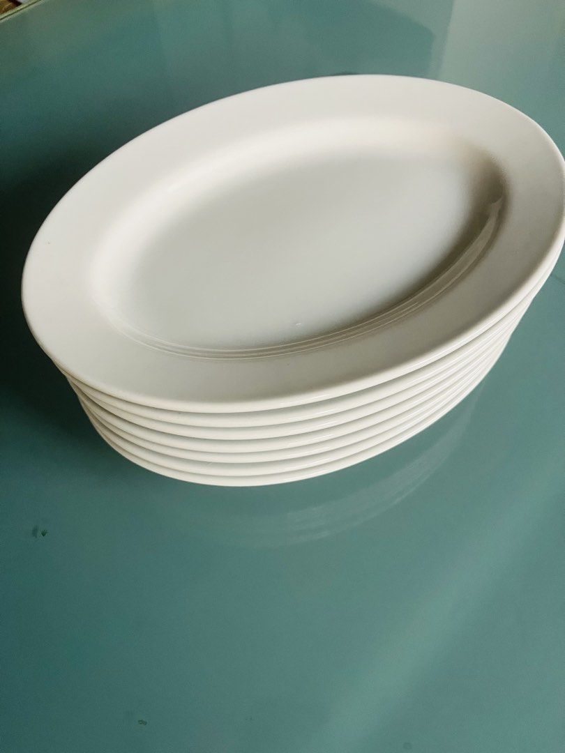 White ceramic oval serving platters (Category: Everything Else Others) located in Quezon City. Submitted by wacpon_061972 (Listing ID 1465041952, Image 2). Description: White ceramic oval serving platters with a clean, rimmed edge. (11pcs).