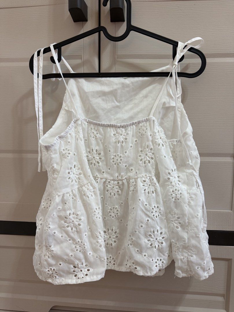 White Eyelet Embroidery seltie top (Category: Sleeveless) located in Valenzuela. Submitted by johnbenerramos (Listing ID 1464973882, Image 2). Description: - Color: White with all-over floral eyelet embroidery - Design: Tiered style with a flattering gathered waistline and square neckline - Straps: Adjustable tie shoulder straps for a custom fit - Back: Elasticated back detailing for extra comfort - Fabric: Lightweight and breathable, ideal for w