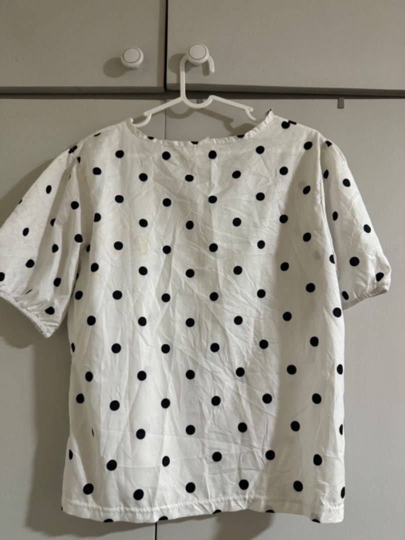 White Polka Dot Short Sleeve Blouse (Category: Blouses) located in Manila. Submitted by tamcloset960 (Listing ID 1465015821, Image 2). Description: - Style: Casual white blouse with classic black polka dots - Sleeves: Puffy short sleeves with subtle gathering - Neckline: Classic round neck - Fit: Relaxed, loose fit for all-day comfort - Material: Light, breezy, and comfortable fabric - Versatility: Easy to style with jeans, shorts, or skirts for 
