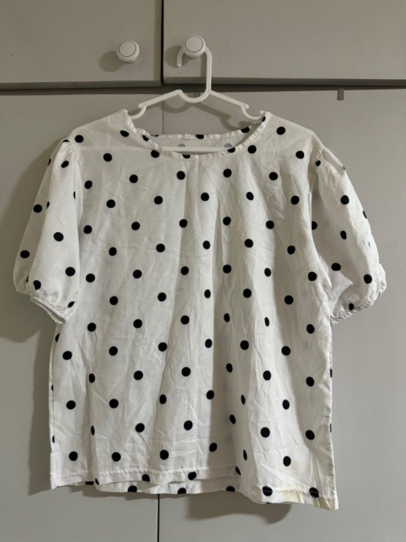 White Polka Dot Short Sleeve Blouse (Category: Blouses) located in Manila. Submitted by tamcloset960 (Listing ID 1465015821, Image 1). Description: - Style: Casual white blouse with classic black polka dots - Sleeves: Puffy short sleeves with subtle gathering - Neckline: Classic round neck - Fit: Relaxed, loose fit for all-day comfort - Material: Light, breezy, and comfortable fabric - Versatility: Easy to style with jeans, shorts, or skirts for 