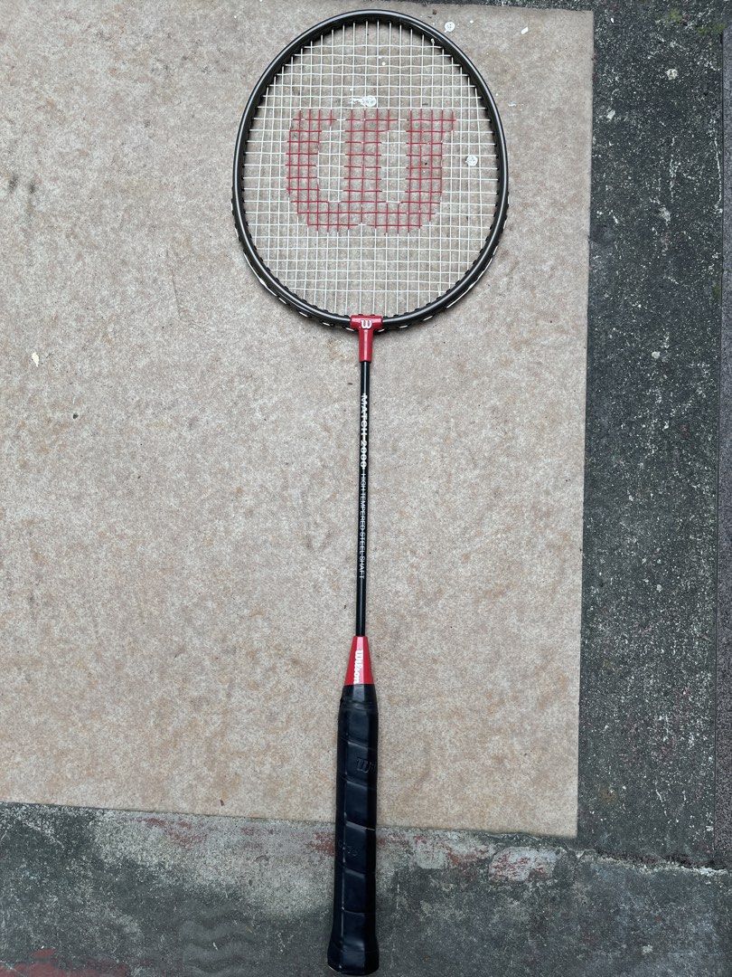 Wilson Match 2000 Badminton Racket (Category: Racket and Ball Sports) located in Quezon City. Submitted by akismurabels (Listing ID 1464990182, Image 1). Description: ORIGINAL Wilson Badminton racket As is NO BAG 1pc only MOP: Gcash MOD: Lalamove Loc: Visayas ave.Quezon City - Brand/Model: Wilson Match 2000 badminton racket - Frame & Shaft: High-tempered steel in black with striking red accents - Strings: Strung in white featuring the classic red