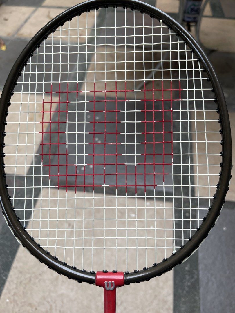 Wilson Match 2000 Badminton Racket (Category: Racket and Ball Sports) located in Quezon City. Submitted by akismurabels (Listing ID 1464990182, Image 3). Description: ORIGINAL Wilson Badminton racket As is NO BAG 1pc only MOP: Gcash MOD: Lalamove Loc: Visayas ave.Quezon City - Brand/Model: Wilson Match 2000 badminton racket - Frame & Shaft: High-tempered steel in black with striking red accents - Strings: Strung in white featuring the classic red