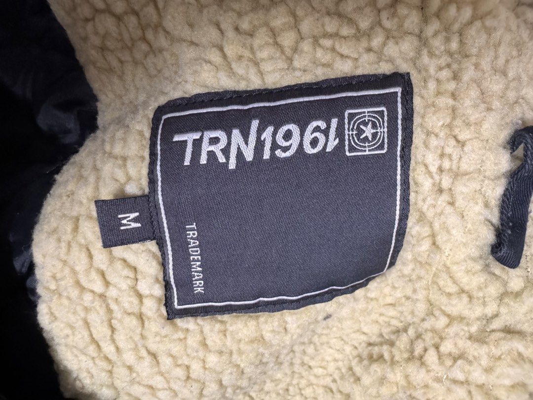 Winter jacket (Category: Coats, Jackets and Outerwear) located in Petaling Jaya. Submitted by cheongyerdua (Listing ID 1465007372, Image 3). Description: a military-style canvas fishtail parka in black (or very dark charcoal faded navy). The design matches a classic M-51 fishtail silhouette, featuring: • A large drawstring hood • An adjustable waist drawstring • Angled flap pockets on the lower front • Mid-thigh utility length.