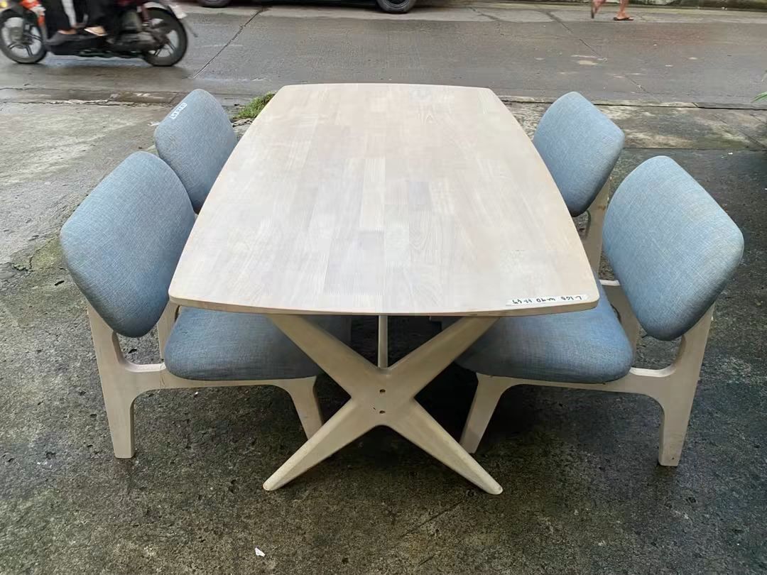 Wooden Dining Table with 4 Blue Cushioned Chairs (Category: Tables & Sets) located in Makati City. Submitted by candyhinojales (Listing ID 1464969189, Image 2). Description: - Set includes: 1 wooden dining table and 4 matching chairs - Table design: Light wood finish with a unique cross-leg base - Chair details: Wooden frames with comfortable soft blue fabric upholstery - Style: Clean, modern look ideal for dining rooms or kitchens - Condition/Bu