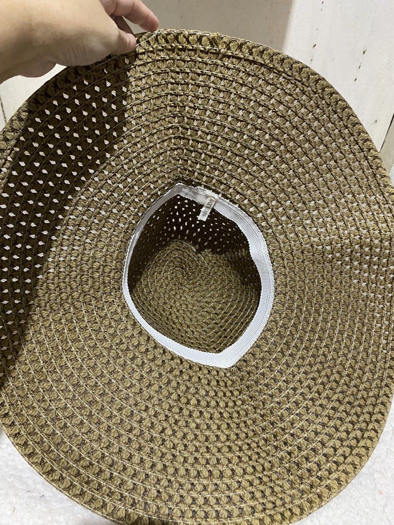 Woven Straw Sun Hat Wide Brim Beach Hat (Category: Hats & Beanies) located in Manila. Submitted by resi.diaz (Listing ID 1465040878, Image 3). Description: - Color: Brown - Material: Lightweight woven straw - Design: Wide brim with open weave pattern for maximum airflow - Comfort: Includes white interior sweatband - Portability: Easy to pack, ideal for beach trips and outdoor walks - Condition: Brand new/Mint.