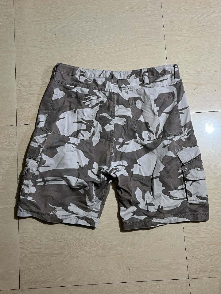Wrangler Camo Cargo Shorts (Category: Shorts) located in Manila. Submitted by kaloyyyyyy (Listing ID 1465027254, Image 2). Description: - Brand: Wrangler - Design: Grey and white camouflage pattern - Material: Durable, rugged cotton - Pockets: Multiple side and back utility pockets plus standard front pockets - Features: Button closure with belt loops - Condition: Excellent, no major flaws or stains spotted - Perfect for: Casual outdoor wear or d