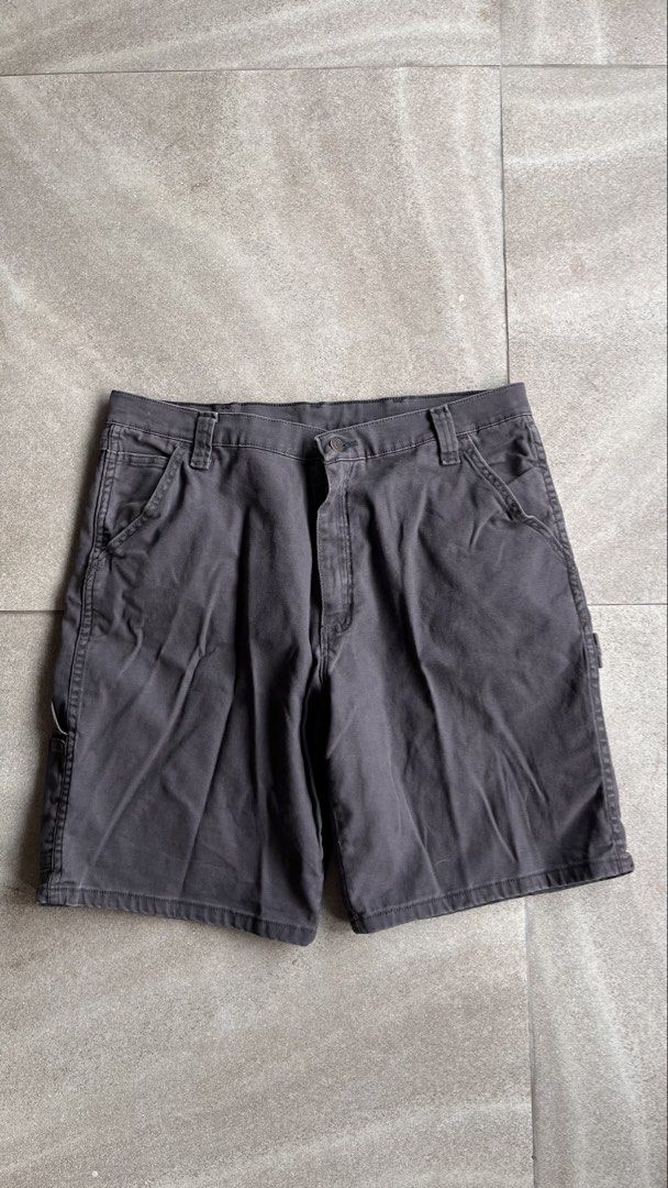 Wrangler Carpenter Shorts Size 36 Grey (Category: Shorts) located in Cabuyao City. Submitted by bulandos (Listing ID 1465048656, Image 2). Description: - Brand: Wrangler - Color: Grey - Size: 36 - Material: Cotton-spandex blend with slight stretch for added comfort - Features: Multiple pockets, utility pocket, and side hammer loop - Closure: Button closure with belt loops - Origin: Made in Mexico - Condition: Clean, washed, and ready to wear.