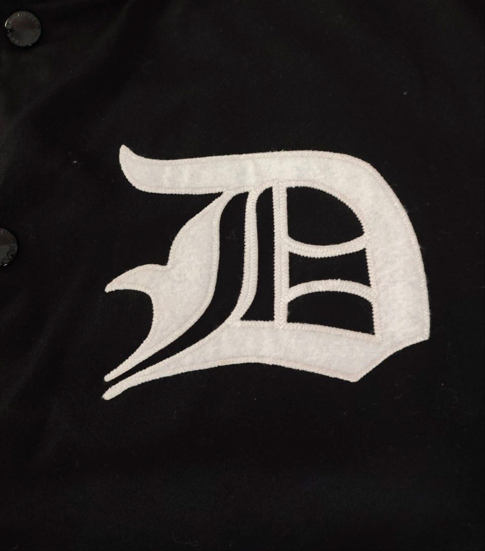 WTAPS Reversible Varsity Jacket Black Floral (Category: Coats, Jackets and Outerwear) located in Makati City. Submitted by rare_thrift_stuff (Listing ID 1464974636, Image 3). Description: - Brand: WTAPS -Dimension 21/24 - Style: Reversible varsity jacket - Side A: Solid black with white 'D' chest patch and striped ribbed trim - Side B: Full tropical flower and leaf print - Closure: Snap buttons down the front - Pockets: Two hand pockets on both s