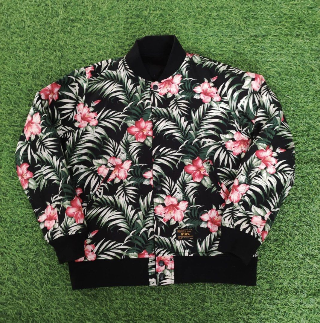WTAPS Reversible Varsity Jacket Black Floral (Category: Coats, Jackets and Outerwear) located in Makati City. Submitted by rare_thrift_stuff (Listing ID 1464974636, Image 2). Description: - Brand: WTAPS -Dimension 21/24 - Style: Reversible varsity jacket - Side A: Solid black with white 'D' chest patch and striped ribbed trim - Side B: Full tropical flower and leaf print - Closure: Snap buttons down the front - Pockets: Two hand pockets on both s