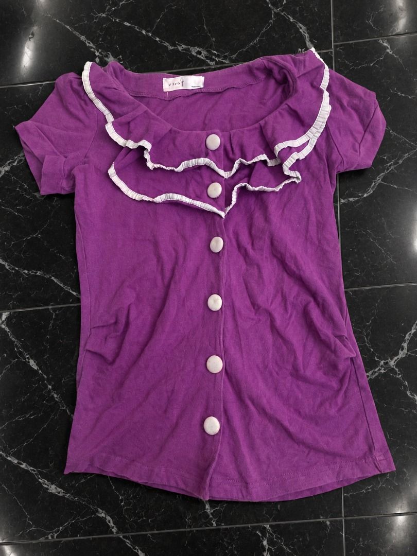 Y2K Purple Ruffle Button-Up Top (Category: Blouses) located in Manila. Submitted by sakki.ph (Listing ID 1465127876, Image 1). Description: purple/lilac Y2K-style ruffle button-up top with a super girly/coquette silhouette! Features a double-layer ruffled neckline with white trim, short sleeves, front button closure, and a slightly fitted shape. The ruffles give it that cute vintage, coquette, fairycore, girly, Y2K mall-girl vibe perfect with low