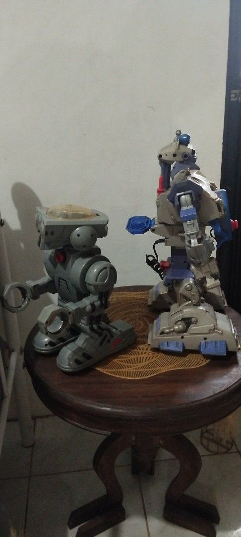 Y2k Vintage Robots (Category: Action & Battle Toys) located in Manila. Submitted by ventajetoyz625 (Listing ID 1464994930, Image 2). Description: - Set of 2 vintage grey and blue robot action figures - sold as set (no breaking of set) - Articulated arms and legs on both figures - 11.5 inch Figure 1: Stamped 2001 Toymax Inc. Made in China - 16.5 inch Figure 2: Stamped 2002 Mattel Inc. China, Model 73352, with attached cord - Condition: Surface dus