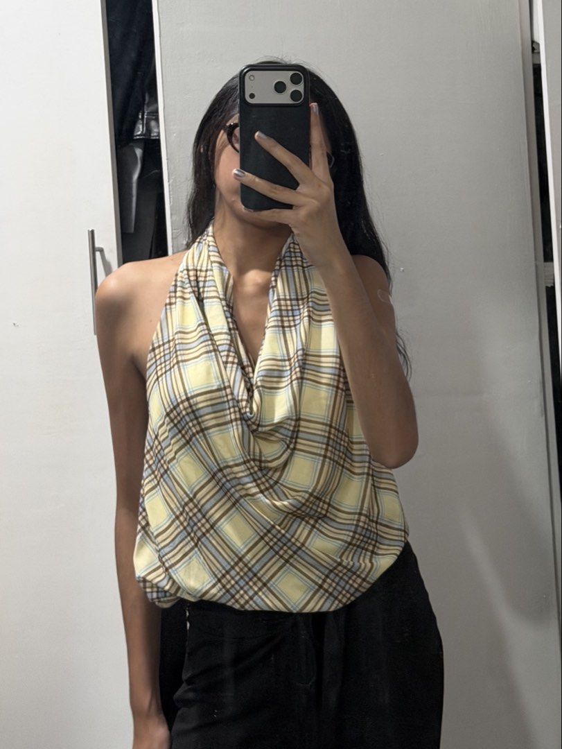 Yellow Plaid Halter Neck Cowl Top (Category: Sleeveless) located in Pasig City. Submitted by miss_abuelita (Listing ID 1465114203, Image 3). Description: - Design: Yellow and white plaid halter top with a flattering cowl neckline and open back - Fit: Free size, comfortably fits small to medium frames - Fabric: Lightweight and breathable, perfect for warm weather or layering - Styling: Pairs effortlessly with black trousers or casual denim - Condi