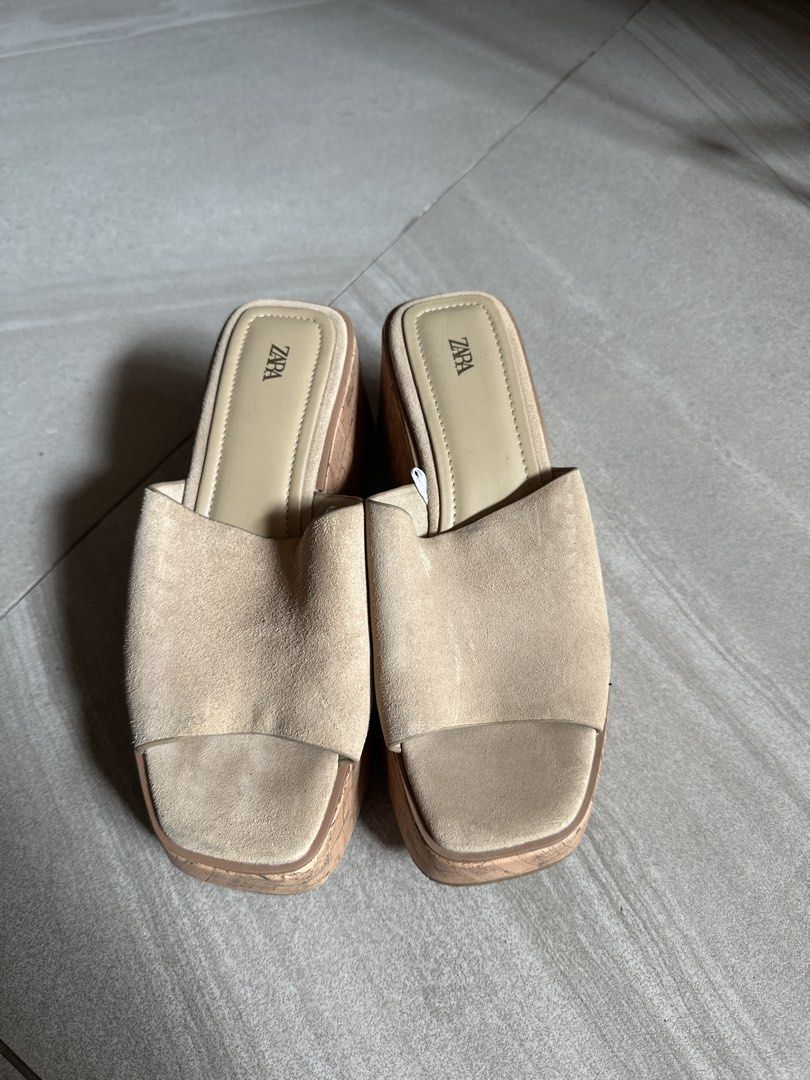 Zara Beige Suede Cork Wedge Sandals (Category: Wedges) located in Muntinlupa City. Submitted by stuffbya (Listing ID 1464972442, Image 2). Description: - Brand: Zara - Style: Platform sandals with chunky cork wedges - Material: Wide suede toe straps - Design: Easy slip-on style - Color: Versatile neutral beige - Features: Good heel height, stable to walk in, clean insoles with clear branding.