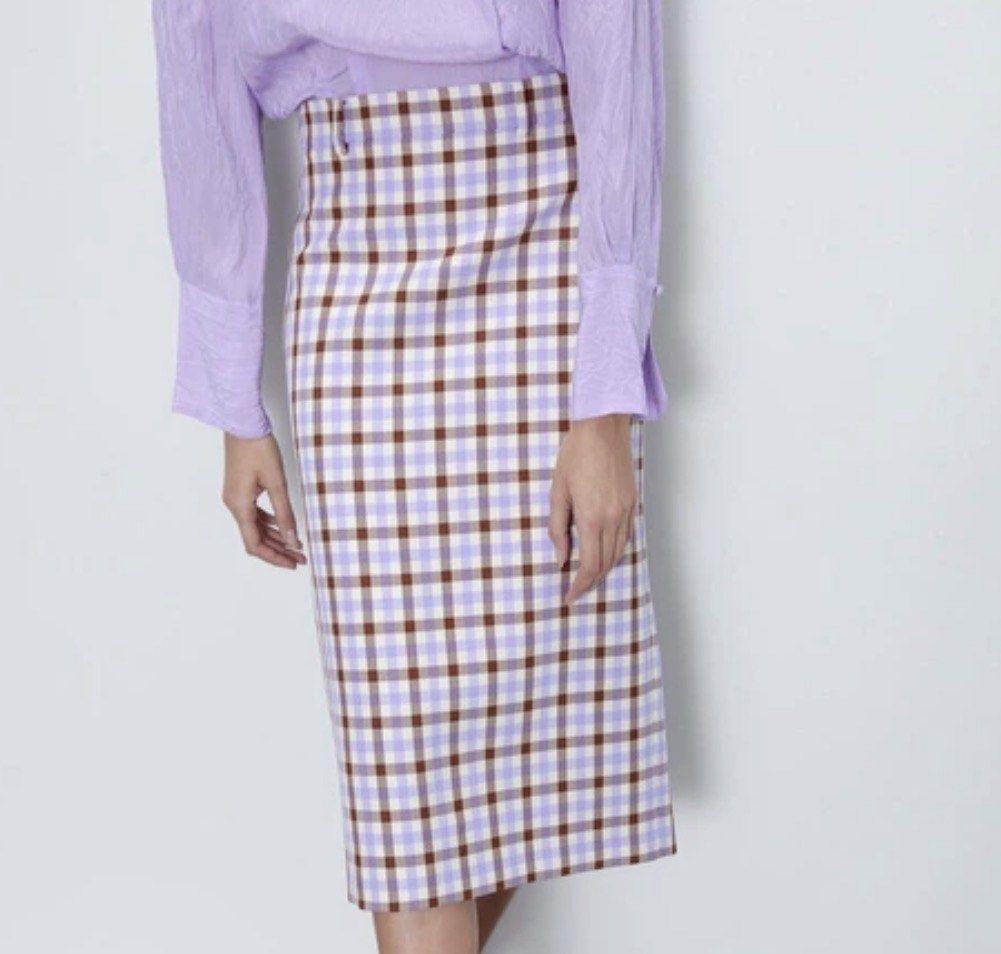 Zara Plaid Midi Skirt (Category: Skirts) located in Makati City. Submitted by agl.ph (Listing ID 1465065565, Image 1). Description: Size S on label but altered to fit an XS waist (25”) Used once - Pattern: Purple, brown, and cream plaid - Fit: High-waisted with a straight cut, mid-calf length - Material: Structured woven fabric - Versatility: Great for casual wear or dressing up with a nice blouse.