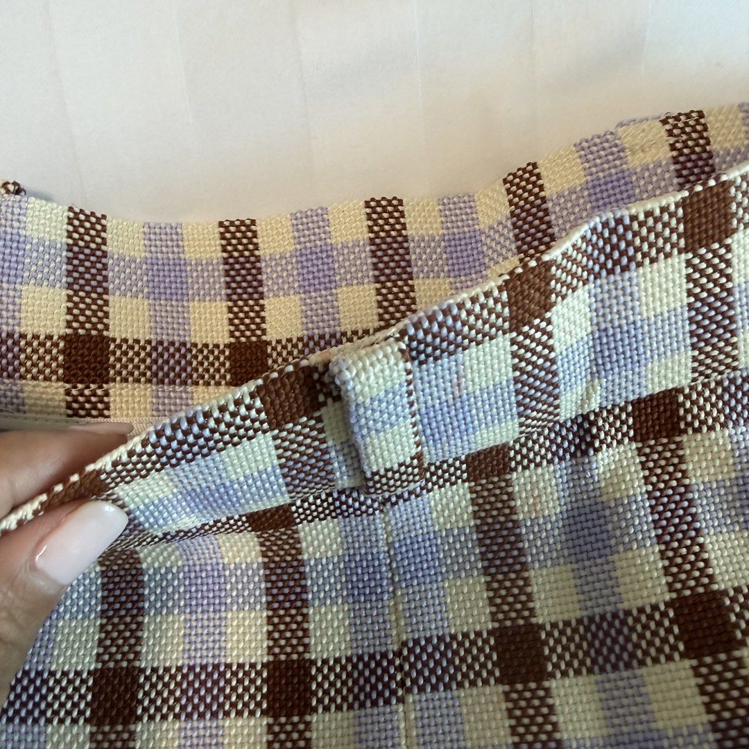Zara Plaid Midi Skirt (Category: Skirts) located in Makati City. Submitted by agl.ph (Listing ID 1465065565, Image 3). Description: Size S on label but altered to fit an XS waist (25”) Used once - Pattern: Purple, brown, and cream plaid - Fit: High-waisted with a straight cut, mid-calf length - Material: Structured woven fabric - Versatility: Great for casual wear or dressing up with a nice blouse.