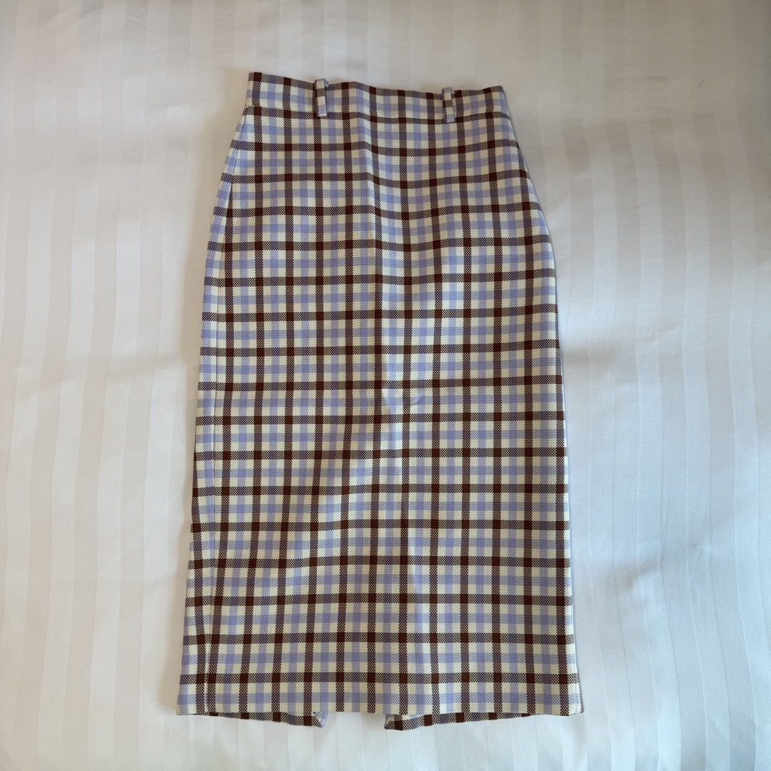 Zara Plaid Midi Skirt (Category: Skirts) located in Makati City. Submitted by agl.ph (Listing ID 1465065565, Image 2). Description: Size S on label but altered to fit an XS waist (25”) Used once - Pattern: Purple, brown, and cream plaid - Fit: High-waisted with a straight cut, mid-calf length - Material: Structured woven fabric - Versatility: Great for casual wear or dressing up with a nice blouse.