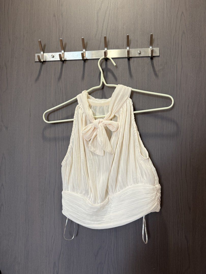 Zara Pleated Halter Neck Crop Top with Back Bow (Category: Sleeveless) located in Manila. Submitted by elisesnts (Listing ID 1465048286, Image 2). Description: - Brand: Zara - Color: Cream - Size: EUR S / USA S / MEX 26 - Design: All-over pleats, halter neckline with back tie-up bow, sleeveless - Material: Lightweight textured fabric - Condition: never used RFS: a bit tight on me.