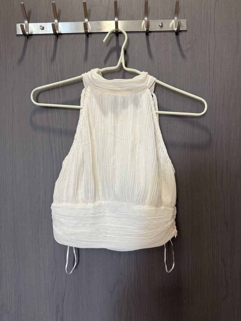 Zara Pleated Halter Neck Crop Top with Back Bow (Category: Sleeveless) located in Manila. Submitted by elisesnts (Listing ID 1465048286, Image 1). Description: - Brand: Zara - Color: Cream - Size: EUR S / USA S / MEX 26 - Design: All-over pleats, halter neckline with back tie-up bow, sleeveless - Material: Lightweight textured fabric - Condition: never used RFS: a bit tight on me.
