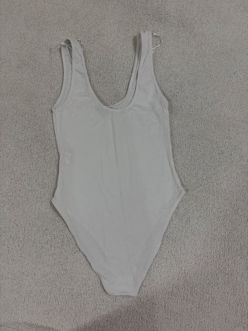 Zara White Bodysuit S (Category: Sleeveless) located in Subic. Submitted by kittysclosetsale (Listing ID 1465093405, Image 2). Description: - Brand: Zara - Style: Sleeveless scoop neck bodysuit with snap bottom closure - Material: Comfortable ribbed cotton - Condition: Brand new with tags (BNWT) - Size: Small (fits true to size) - Perfect as an everyday basic layering piece.