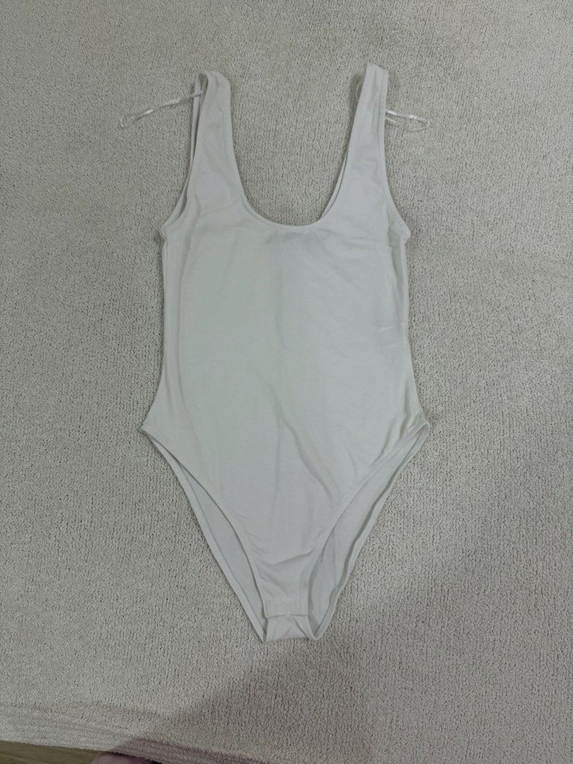 Zara White Bodysuit S (Category: Sleeveless) located in Subic. Submitted by kittysclosetsale (Listing ID 1465093405, Image 1). Description: - Brand: Zara - Style: Sleeveless scoop neck bodysuit with snap bottom closure - Material: Comfortable ribbed cotton - Condition: Brand new with tags (BNWT) - Size: Small (fits true to size) - Perfect as an everyday basic layering piece.