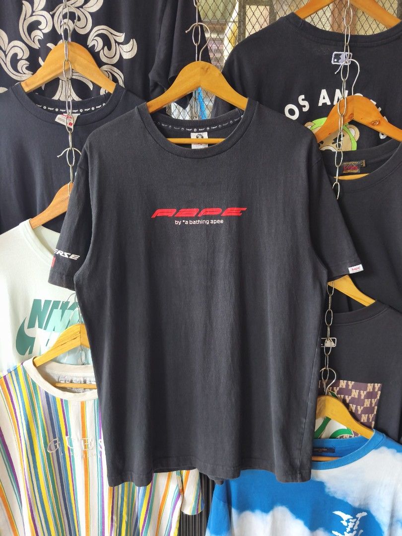 AAPE by A Bathing Ape Graphic Tee XL (Category: Tshirts & Polo Shirts ) located in Pasig City. Submitted by nich_ (Listing ID 1459563641, Image 1). Description: - Black AAPE t-shirt - Size XL 23x30 - Front graphic design - Iconic ape head logo in checkered circle on back - AAPE Universe and other logos on sleeve - Ideal for streetwear fans.