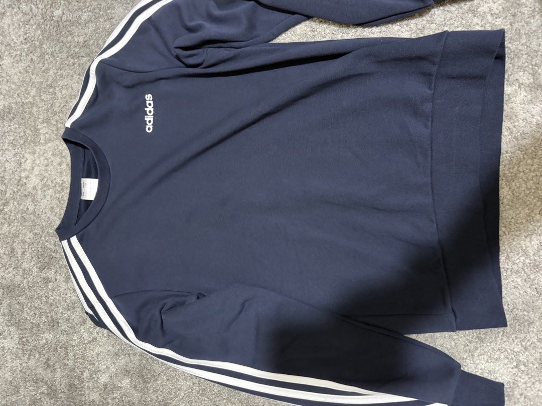 Adidas Navy Blue Sweatshirt with White Stripes (Category: Longsleeves) located in Paranaque City. Submitted by jaietyrone04915 (Listing ID 1459644863, Image 1). Description: - Classic navy blue Adidas sweatshirt - Iconic white stripes on sleeves - Comfortable and casual design - Ideal for everyday wear - Size: Medium (M).