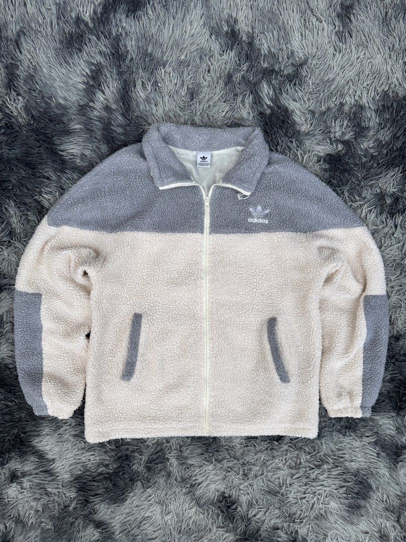 Adidas Sherpa Fleece Full Zip Jacket (Category: Coats, Jackets and Outerwear) located in Manila. Submitted by re_wear26 (Listing ID 1459569082, Image 2). Description: - Super cozy Adidas sherpa fleece jacket - Stylish cream and grey color blocking - Iconic Adidas trefoil logo on the front - Large trefoil logo on the back - Full zip closure for easy wear - Convenient pockets for essentials - Ideal for keeping warm and comfortable.