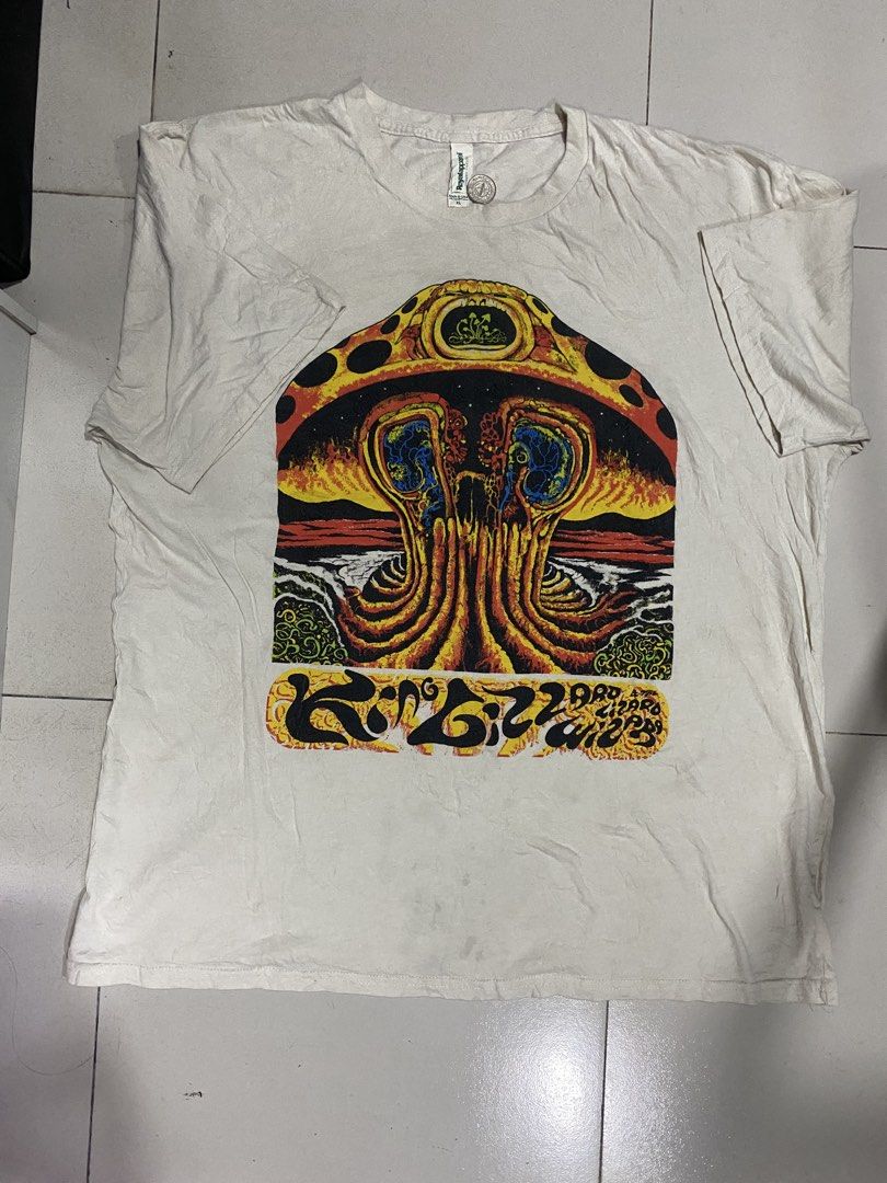 Royal Apparel Graphic T-Shirt (Category: Tshirts & Polo Shirts ) located in Baliuag. Submitted by macyjoythrift (Listing ID 1459519072, Image 2). Description: - Need Wash ,Madumi Fresh from Bale -Cream colored American Apparel t-shirt - Unique psychedelic mushroom graphic print with vibrant colors and intricate details - Features 'King Gizzard & The Lizard Wizard 2019' text at the bottom - Ideal for fans of the band or psychedelic art enthusiasts