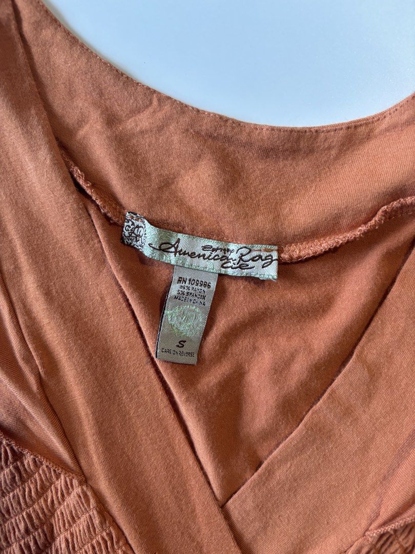 American Rag Smocked V-Neck Top (Category: Sleeveless) located in Batac City. Submitted by doniagel (Listing ID 1459500881, Image 2). Description: - Cute top from American Rag - Smocked bodice with V-neckline - Cap sleeves with slight ruffle - Soft fabric blend - Versatile for casual or dressy occasions - Easy to pair with jeans or skirts - size s-m - stretchable.