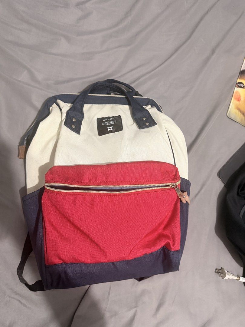 Anello Backpack Navy White Red (Category: Backpacks) located in Manila. Submitted by ellede32655 (Listing ID 1459627416, Image 2). Description: - Anello backpack - Color: Navy blue, white, and red color blocking - Main compartment with internal pockets - Front zip pocket for easy access - Versatile carrying options: top handles and adjustable shoulder straps - Ideal for daily commutes or travel adventures.