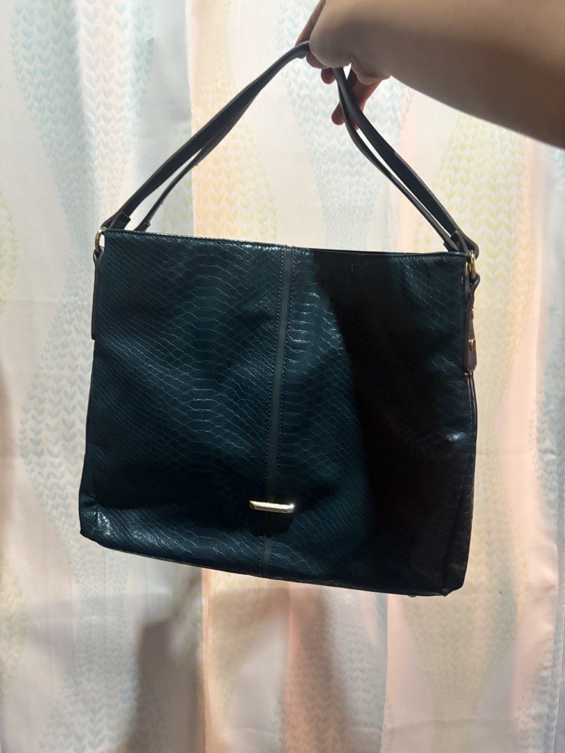 Anne Klein Teal Embossed Shoulder Bag (Category: Shoulder Bags) located in Laoag. Submitted by eggs.sam.cheese (Listing ID 1459581838, Image 2). Description: - Stylish teal shoulder bag - Snake-like embossed texture - Fun polka dot interior lining - Spacious three compartment - Elegant gold-tone hardware accents - Barely seen minimal issue in the last photo.