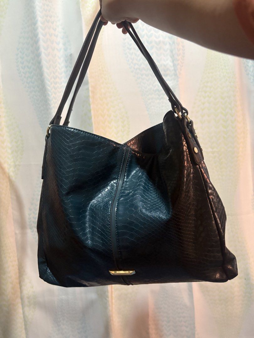 Anne Klein Teal Embossed Shoulder Bag (Category: Shoulder Bags) located in Laoag. Submitted by eggs.sam.cheese (Listing ID 1459581838, Image 1). Description: - Stylish teal shoulder bag - Snake-like embossed texture - Fun polka dot interior lining - Spacious three compartment - Elegant gold-tone hardware accents - Barely seen minimal issue in the last photo.