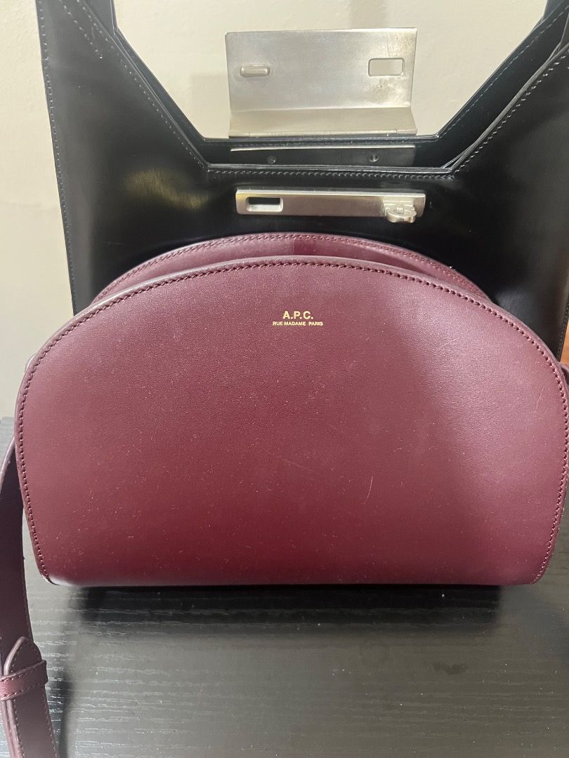 A.P.C. Burgundy Leather Shoulder Bag (Category: Shoulder Bags) located in Pasay City. Submitted by sharshay317 (Listing ID 1459597782, Image 1). Description: Burgundy leather shoulder bag from A.P.C. Features a half-moon shape with a zip closure. The strap has a gold buckle for adjustment. The leather has a nice sheen. Stitching details are clean and precise. A classic piece for everyday use. A slight scratch in the middle but not really noticeab
