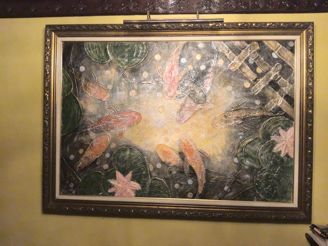 Arts by Angel Moreno (Category: Wall Decor) located in Manila. Submitted by snooks1938 (Listing ID 1459496948, Image 3). Description: Up for Sale.. Koi Fish by ANGEL MORENO YEAR 2007 SIZE 45 X 75 - Large framed painting of koi fish in a pond - Features lily pads and a textured finish - Ornate, gold-colored frame - Signed 'MOON OO DA' (bottom right) - Makes a stunning statement piece for any wall.