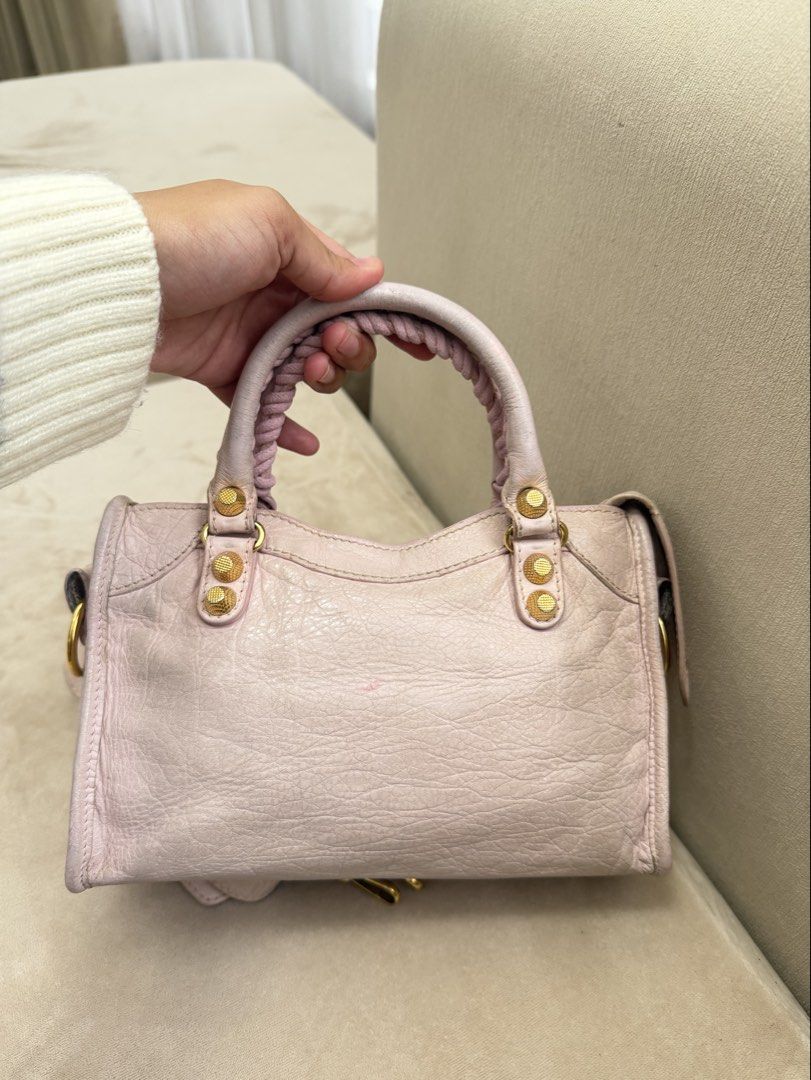 Authentic Balenciaga Mini City Big Giant Stud (Category: Luxury Bags & Wallets) located in Manila. Submitted by maria_2326 (Listing ID 1459602119, Image 2). Description: Balenciaga Mini City Big Giant Stud Baby Pink | Guarantee Authentic With strap only Flaw: Please see details photos, dirt on body, handle wears, corner wears/rubs. Needs bag spa No lowballing! Location: Manila/QC.