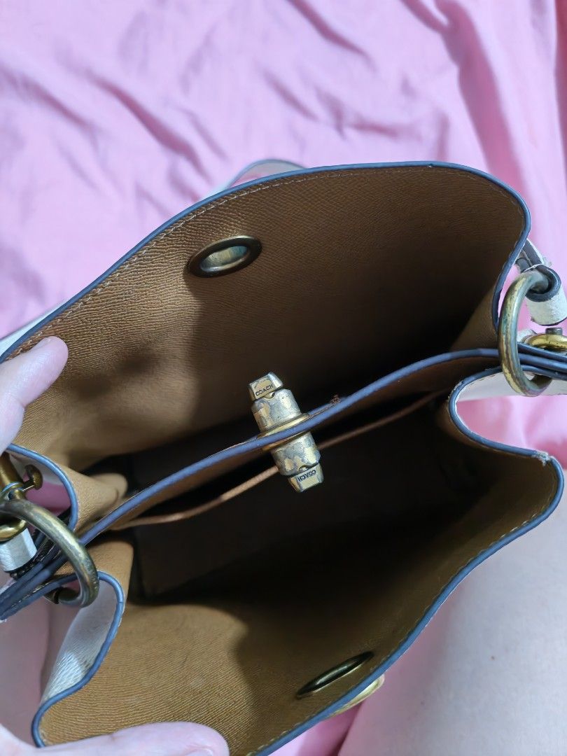Authentic Coach (Category: Shoulder Bags) located in Quezon City. Submitted by preetycindz (Listing ID 1459639779, Image 3). Description: - Stylish white bucket bag - Pebbled texture material - Secure turn-lock closure - Adjustable shoulder strap - Spacious enough for daily essentials - Clean and well-maintained interior 100% Original coach.