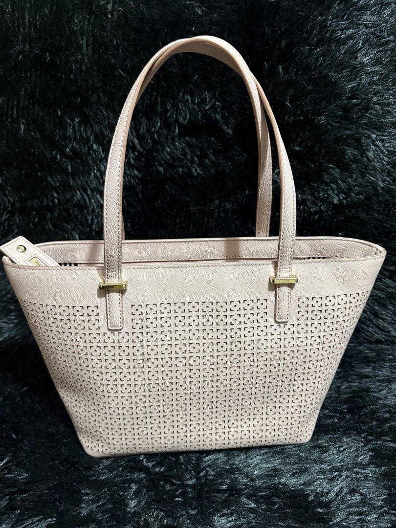 Authentic Kate Spade Pink Perforated Leather Tote Bag (Category: Tote Bags) located in Pasig City. Submitted by fiercemoon_f4c53e (Listing ID 1459541409, Image 2). Description: - Authentic Pink Kate Spade Tote Bag - Stylish perforated design on the front - Elegant gold hardware details - Interior lined with black and white stripes - Secure zipper closure - Note: Minor yellow stains present inside the main compartment Good as new Bought in Japan🇯