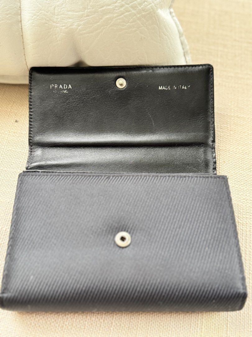 Authentic Vintage Prada Ribbed Canvas Medium Trifold Wallet (EVC) (Category: Luxury Bags & Wallets) located in Rizal. Submitted by mymnlshoppe (Listing ID 1459572747, Image 3). Description: Selling a rare Vintage Prada Medium Trifold Wallet in classic black. Features a distinct ribbed textured canvas exterior with the iconic woven horizontal PRADA block logo. The interior is fully lined with soft black calfskin leather and Prada monogram jacquard
