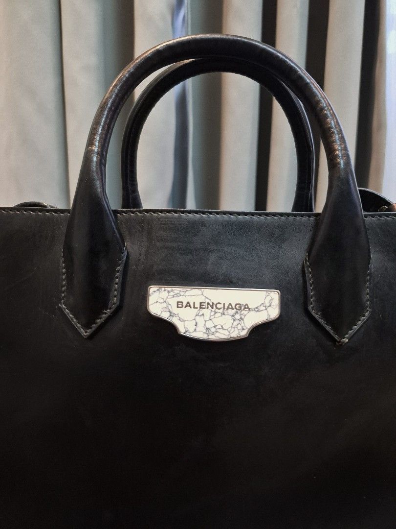 Balenciaga Black Padlock Leather Top Handle Bag (Category: Luxury Bags & Wallets) located in Manila. Submitted by unknowncloset (Listing ID 1459575541, Image 2). Description: - Genuine black leather Balenciaga handbag - Classic top handle design - Signature Balenciaga logo plate on the front - Ample interior space for essentials - Versatile for daily use or special occasions - Elevates any outfit with its stylish appeal.