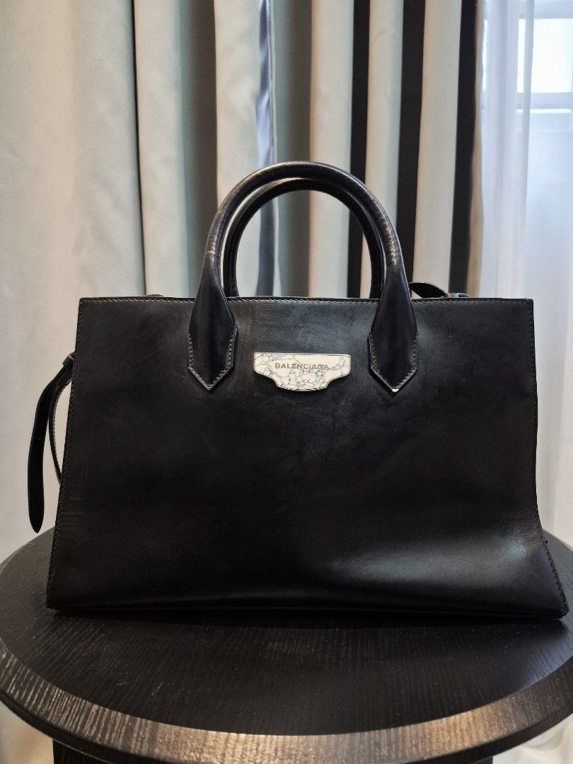 Balenciaga Black Padlock Leather Top Handle Bag (Category: Luxury Bags & Wallets) located in Manila. Submitted by unknowncloset (Listing ID 1459575541, Image 1). Description: - Genuine black leather Balenciaga handbag - Classic top handle design - Signature Balenciaga logo plate on the front - Ample interior space for essentials - Versatile for daily use or special occasions - Elevates any outfit with its stylish appeal.