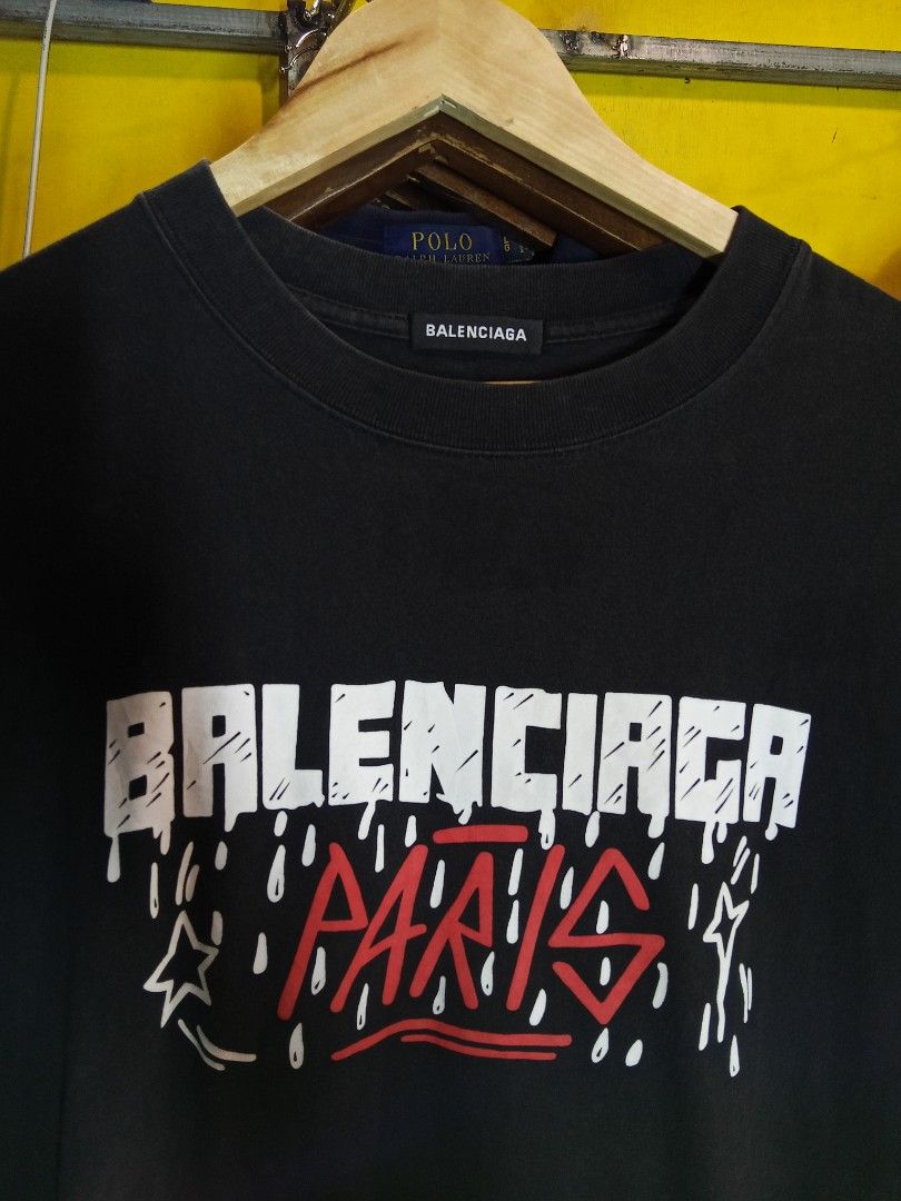 Balenciaga Paris T-shirt (Category: Tshirts & Polo Shirts ) located in Lucban. Submitted by aeronroyyy (Listing ID 1459556554, Image 2). Description: - Authentic Balenciaga Paris graphic t-shirt - Features iconic Balenciaga logo with 'Paris' text - Estimated size S (please check tag and photos for fit) - Made from soft, comfortable cotton - Ideal for everyday casual wear - Detailed design visible in provided photos.