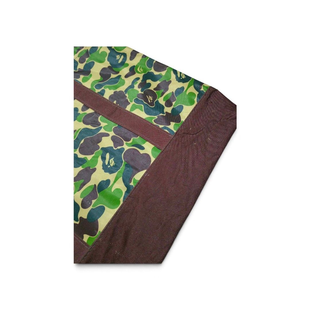 BAPE Camo Tote Bag Green (Category: Luxury Bags & Wallets) located in Manila. Submitted by southstreethub.ph (Listing ID 1459582833, Image 3). Description: - BAPE green camouflage pattern - Condition: Very Good Conditio - Dimention: 19 Width 14 Lenght - Durable canvas material - Two comfortable top handles - Spacious interior for all your essentials - Ideal for everyday use or as a fashion statement - Price: 999 Plus Shipping fee.