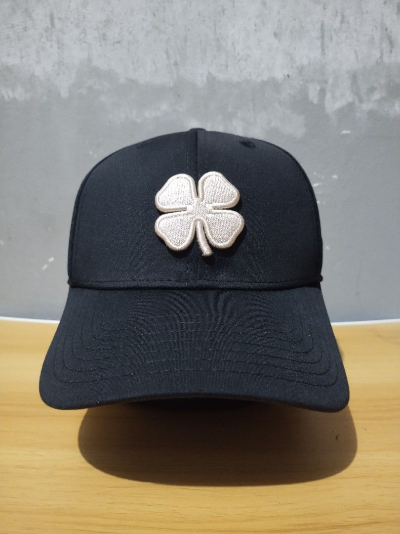Black Clover Live Lucky Fitted Golf Cap (Category: Caps & Hats) located in Angeles City. Submitted by thehustlersculture (Listing ID 1459602412, Image 1). Description: - Brand: Black Clover - Type: Baseball Cap - Design: Signature clover logo on front - Embroidery: "Live Lucky" on the side - Back Detail: "BLACK CLOVER" and "blackcloverusa.com" tag - Fit: Adjustable strap for a comfortable fit - Occasion: Ideal for casual wear.